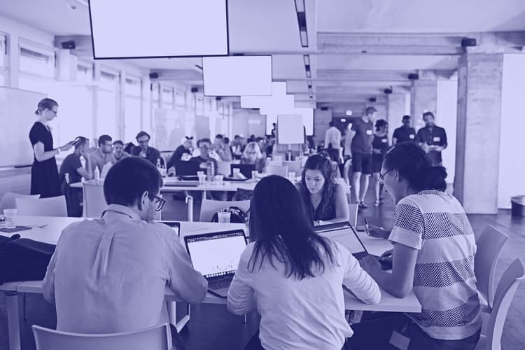 Group of software engineers with their laptops, coding for the N3XTCODER hackathon