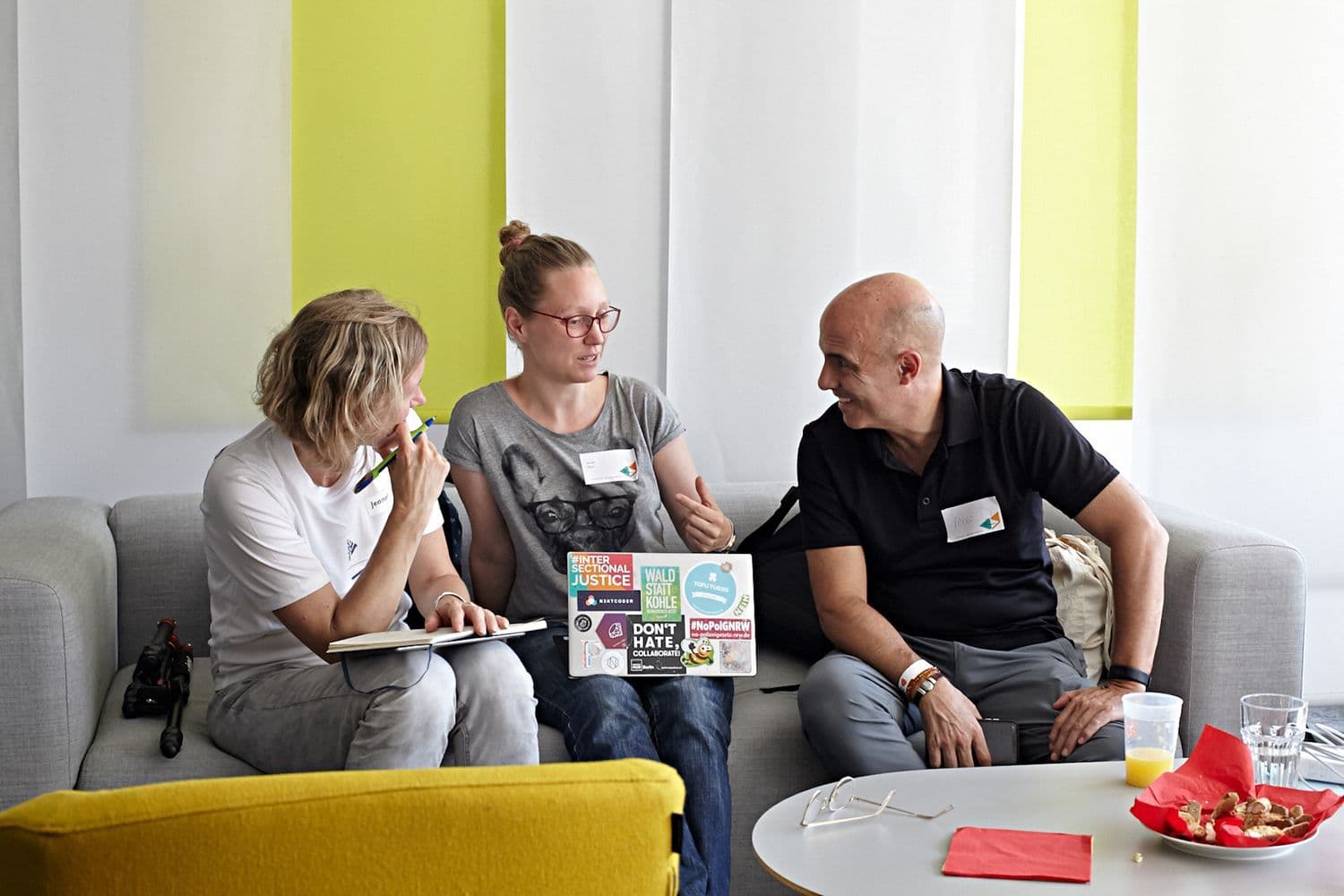 Volunteers of the Hackathon sitting together and discussing.