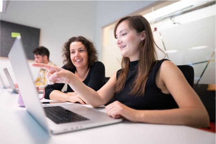 Photo shows people from the N3xtcoder team working together in the office