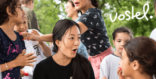 Volunteer from Vostel playing with children in the park